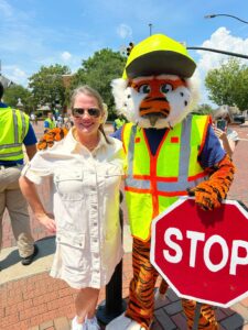 Laura Sellers posing with Aubie the Auburn University mascot at a summer alumni celebration in Auburn, Alabama.