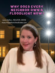 Bright floodlight shining over a suburban Auburn neighborhood at night