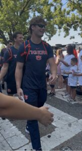 Auburn football players walking through Tiger Walk with cheering fans