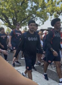 Auburn football players walking to Jordan-Hare Stadium