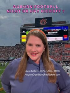 Auburn fans cheering under the lights at Jordan-Hare Stadium.