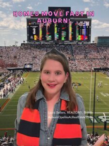 Auburn home for sale sign with orange and blue shakers in the yard.