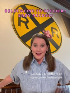 Downtown Opelika streetscape and Auburn skyline in the distance