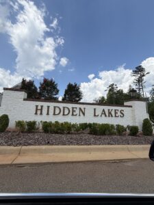 Hidden Lakes neighborhood entrance in Opelika Alabama featuring beautiful homes and landscaped community