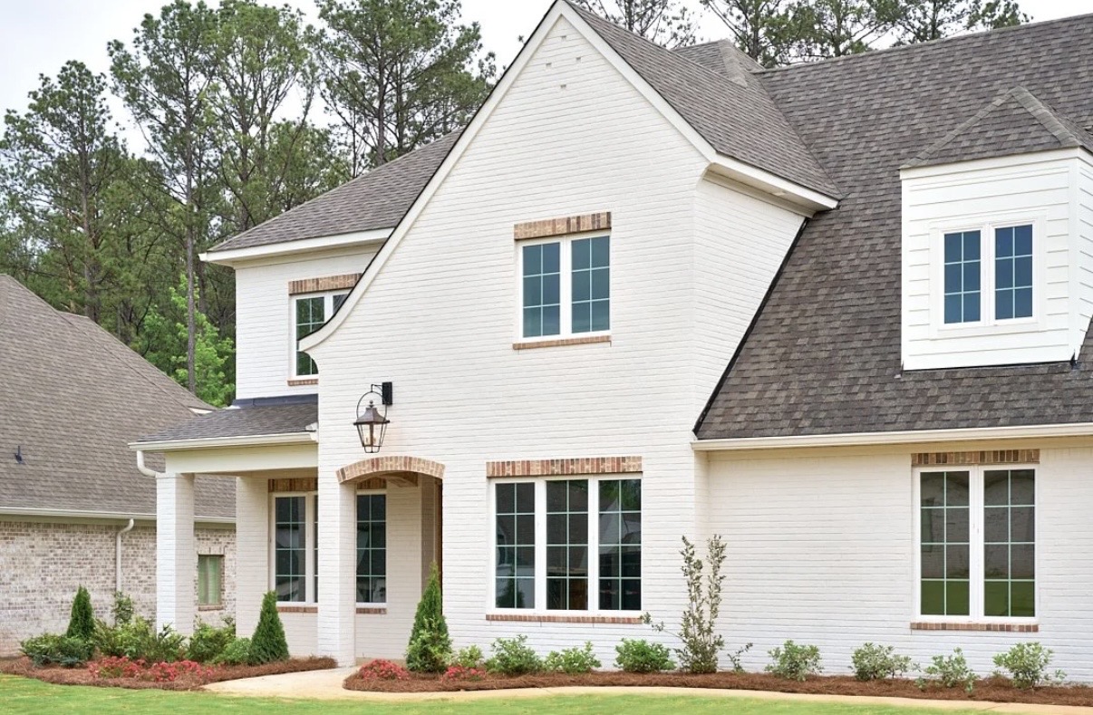 White brick home with a landscaped front yard in Auburn, Alabama