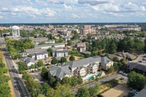 Aerial view of Auburn condominium buildings with Auburn University in the background