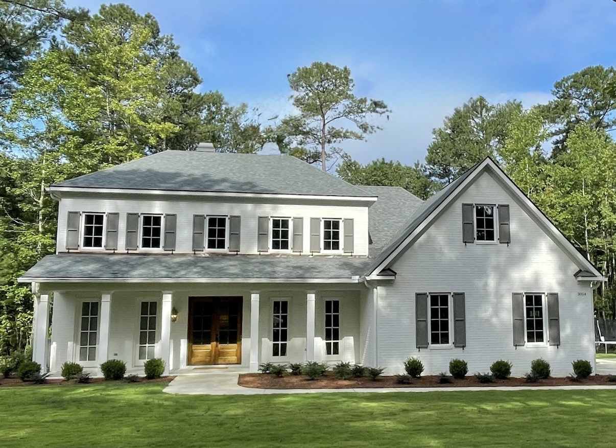 White two-story home with a front porch in Opelika, Alabama